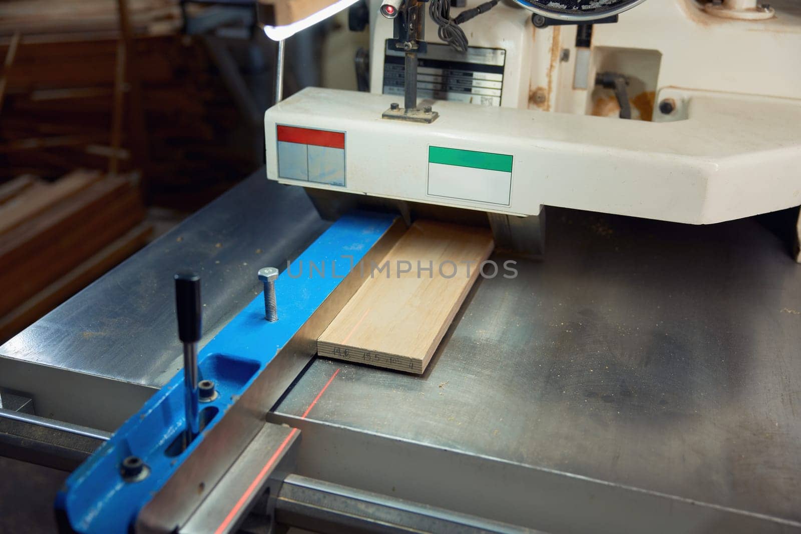 Thickness planer machine to trim wood plank closeup view. Woodworking workshop and carpentry work concept