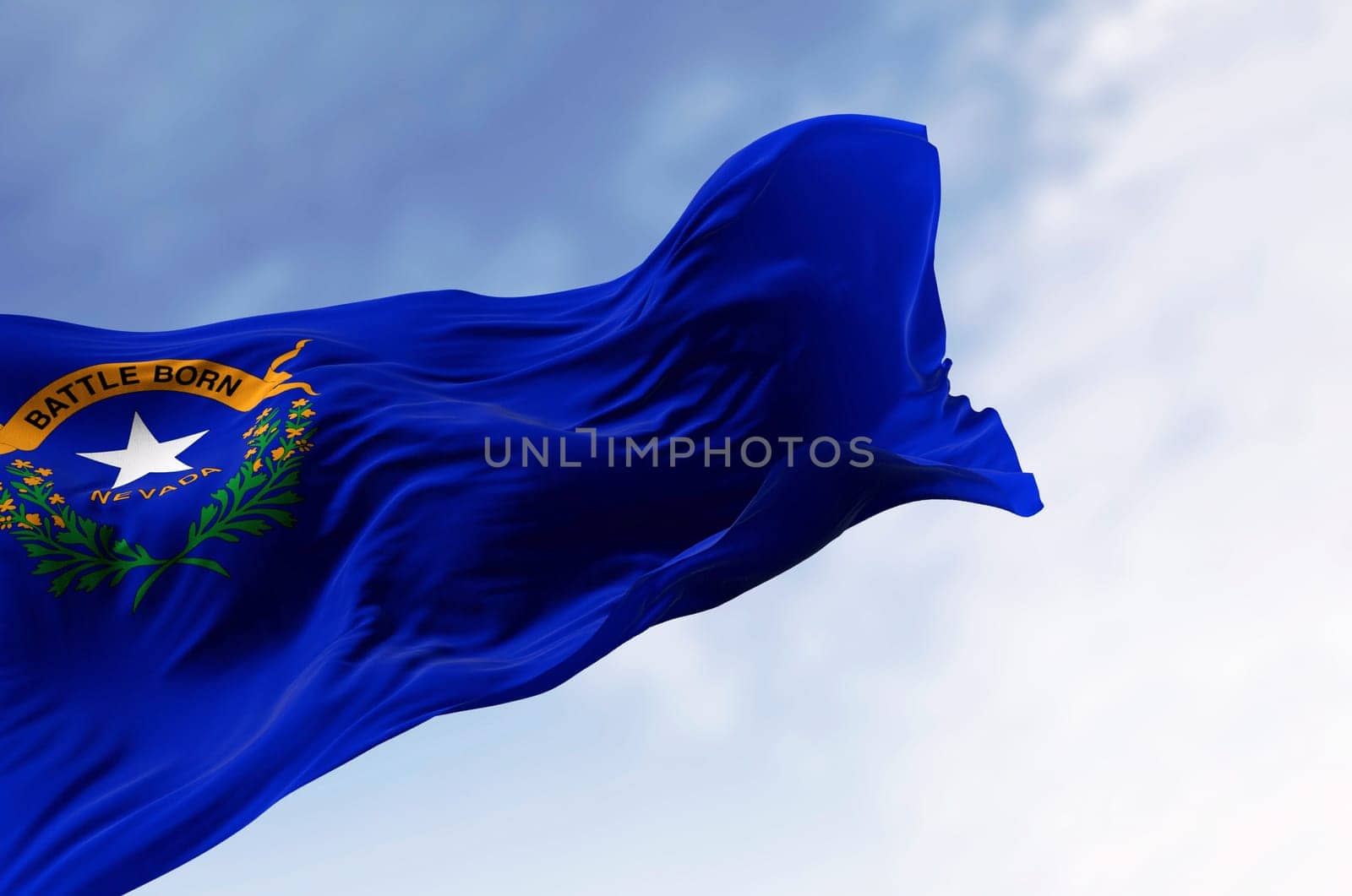 Nevada state flag waving in the wind on a clear day. Cobalt blue field with a state emblem on the top left. 3d illustration render. Rippled fabric