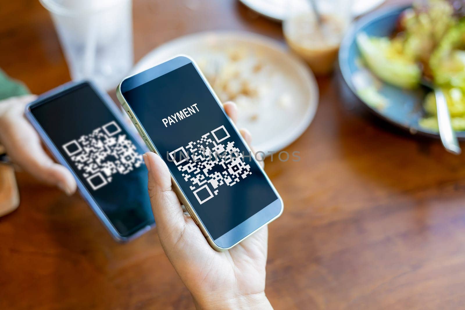 Hands holding mobile phone, Hand using mobile phone application to scan QR code, Qr code payment or cashless technology concept, Coffee shop accepting digital pay without money, Meaningless QR code.