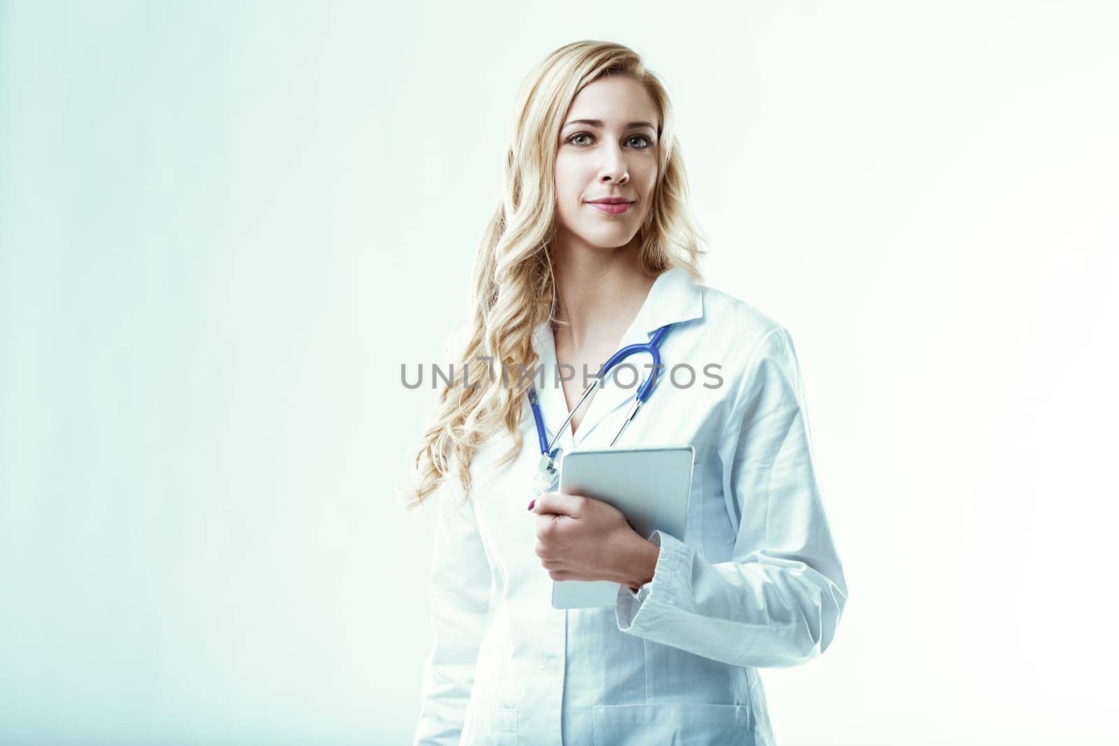 Confident doctor stands holding a digital tablet, symbolizing the integration of technology and healthcare, improving diagnoses, treatments, and patient care