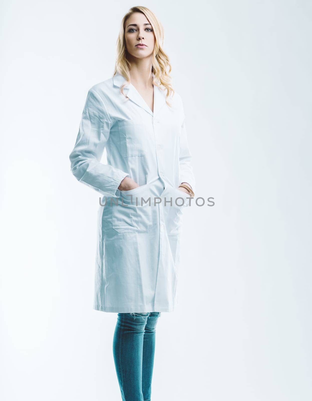 Young female doctor or scientist standing confidently with hands in pockets, embodying the fusion of artificial intelligence and automation in healthcare innovation