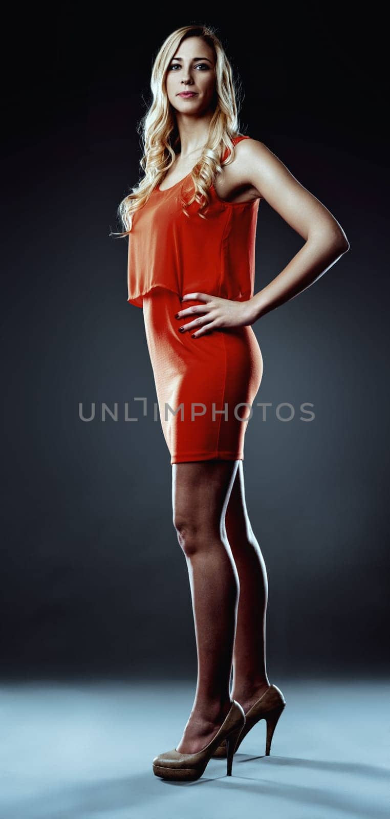 Businesswoman in a stylish orange dress stands confidently, ready to embrace the challenges and opportunities of artificial intelligence and automation in her professional life