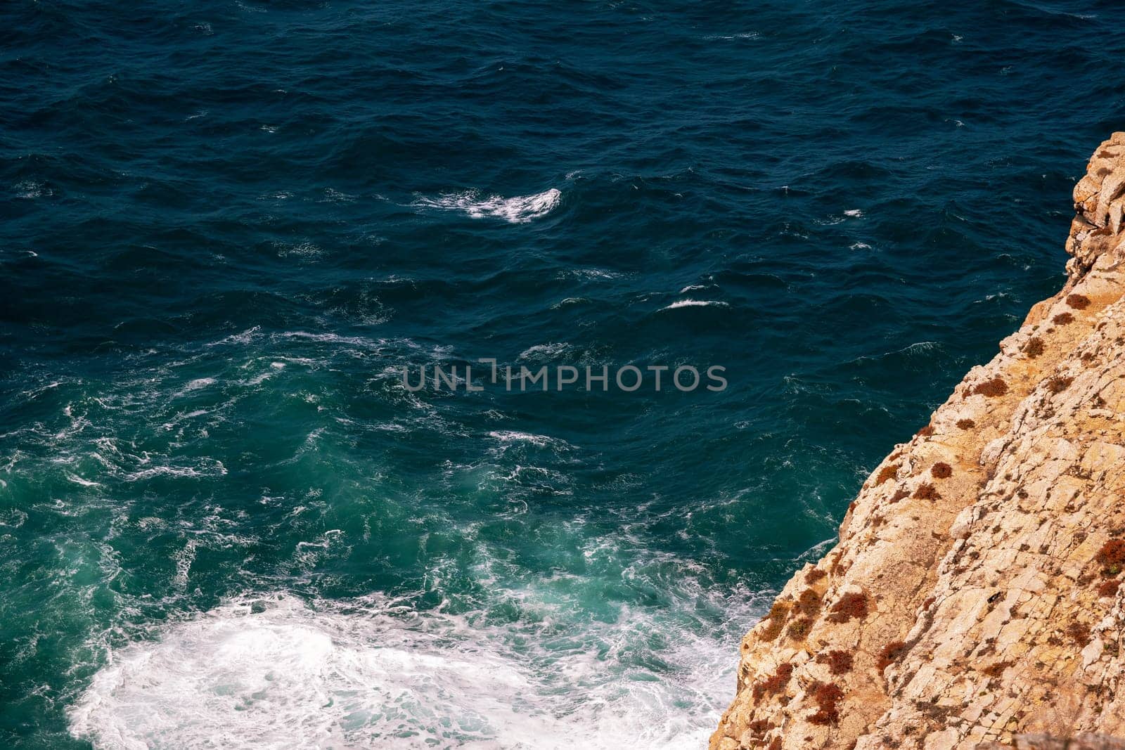 Rocky landscape. Scenic view of sea and Portugal Algarve Cliffs. A beautiful coastline with rocky shore and yellow rocks. Travel destination.