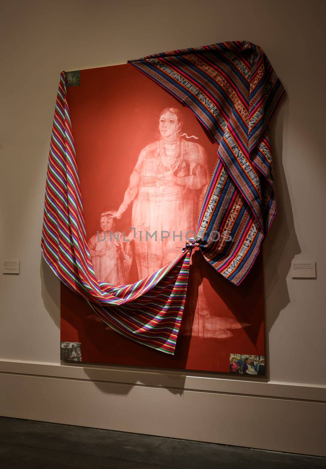 Venice, Italy - May 7 2024: 60th Art Biennale in Venice. Miscegenation Masks VII, Moxa Nation Woman and Infant. Red iron oxide, press clippings,  imitation gold leaf and cotton Andean Fabric on canvas