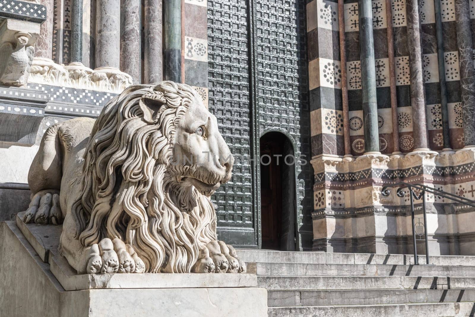 Genoa, Italy - 28 December 2023: the guard lion at the entrance of the Duomo - most important church of the town