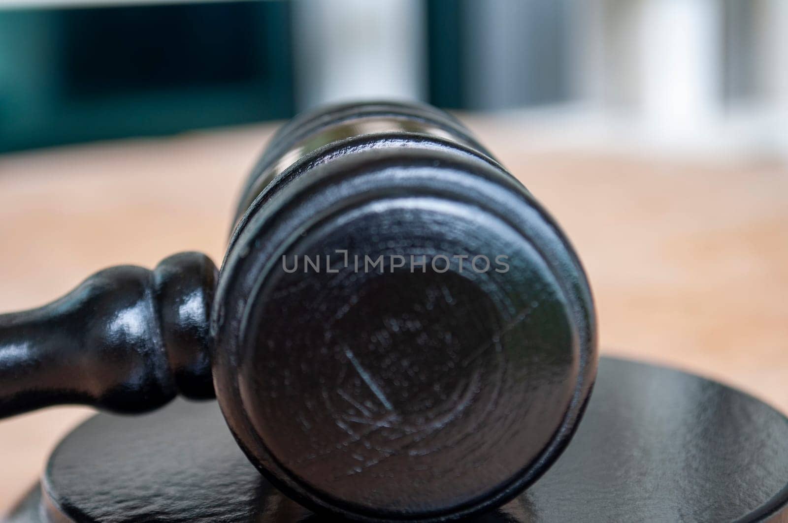 Close up of gavel next to prison. Law and regulation concept.