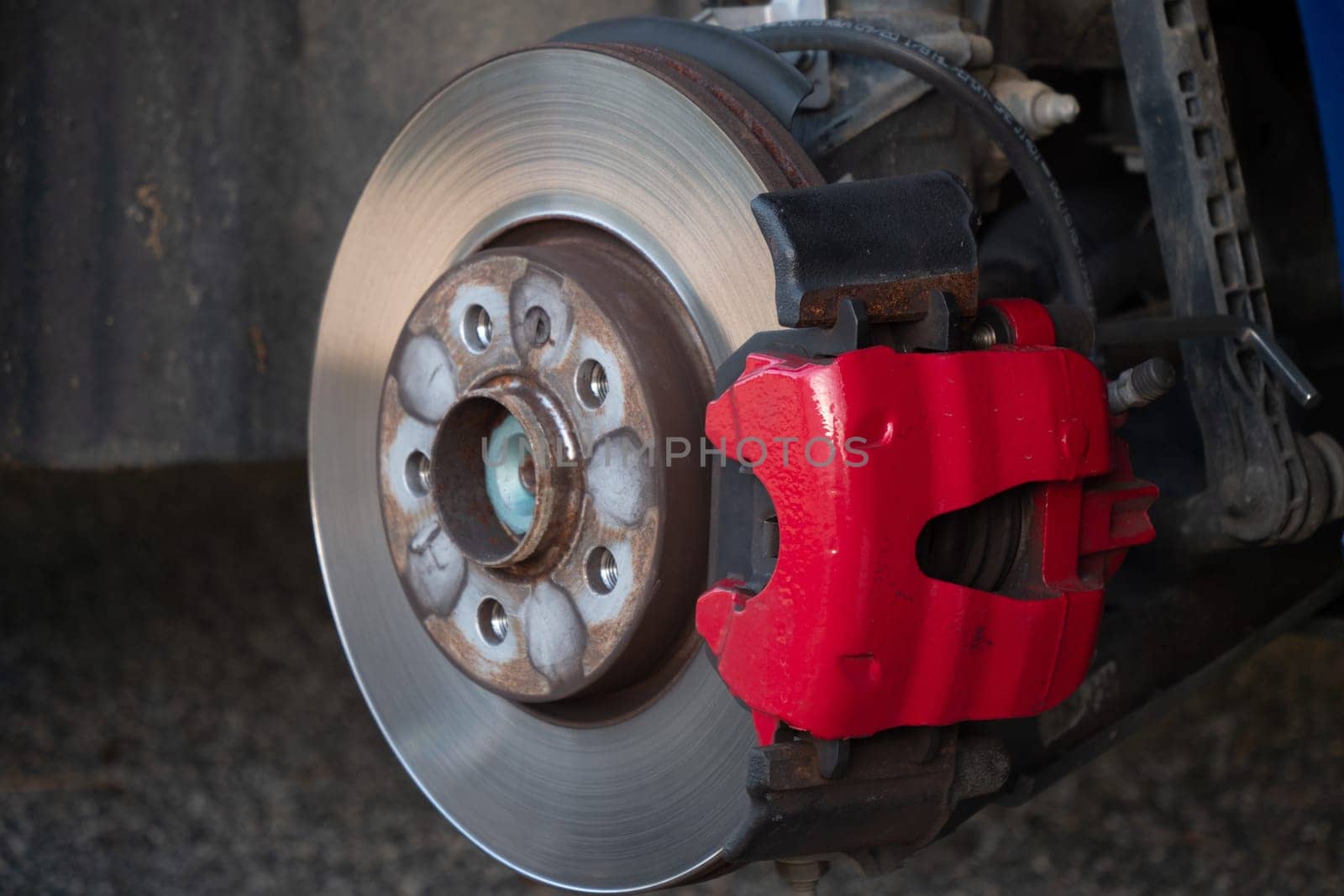 A red brake caliper and the disc is shiny