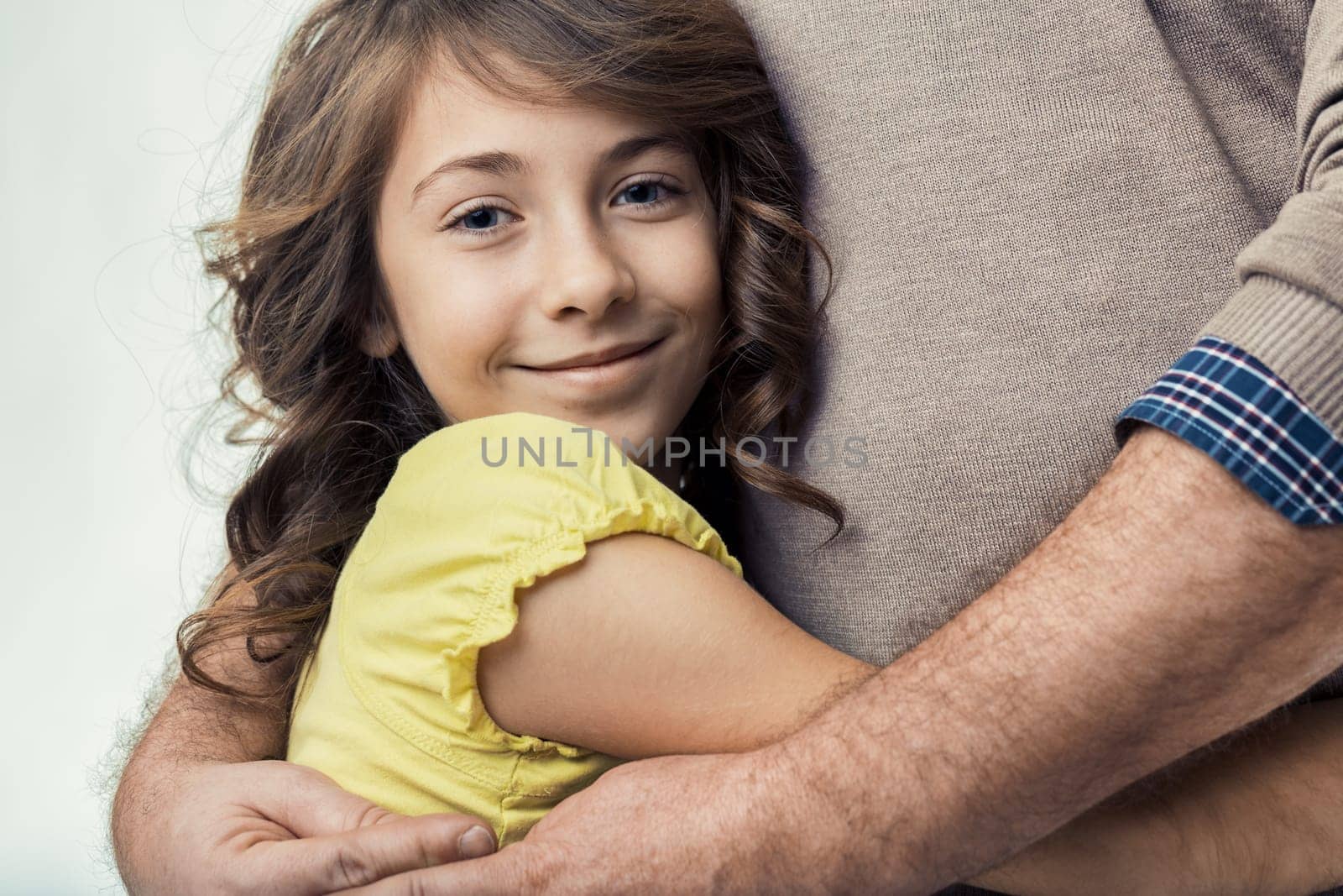 Young daughter embracing her father, arms wrapped around him in a heartwarming display of love and trust, highlighting the deep familial bond shared between them