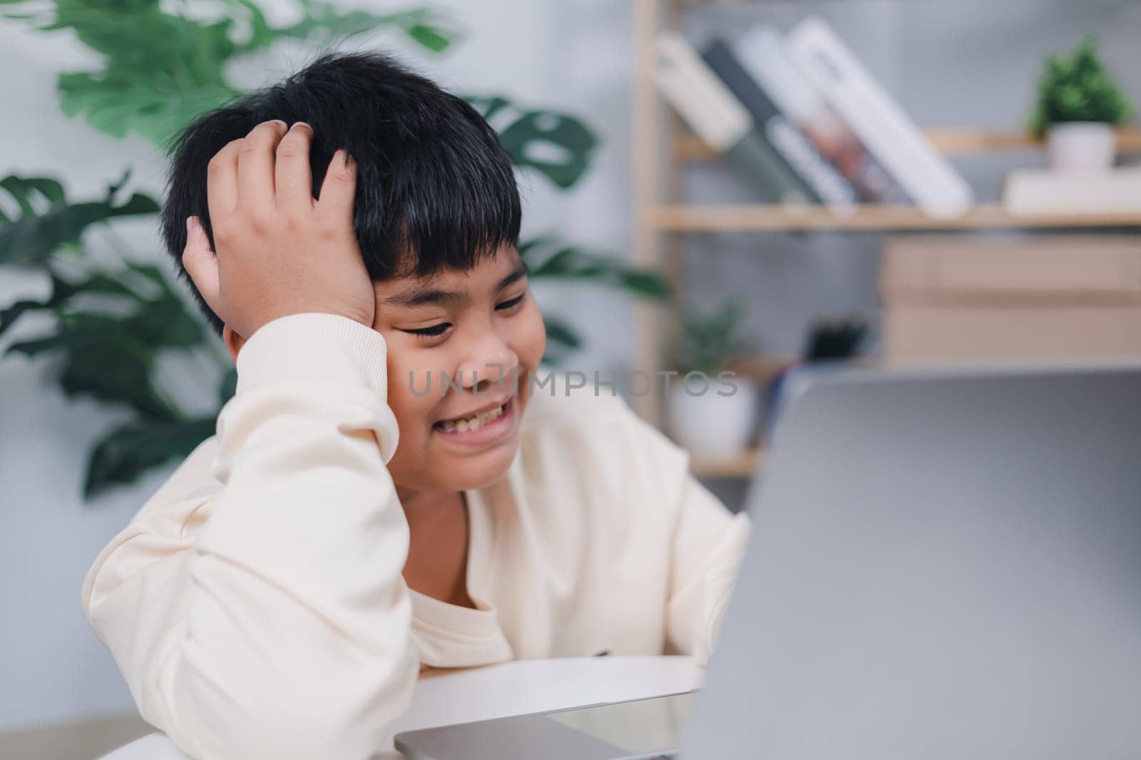 Asian boy using tablet learning, Educational of tech concept, Staying at home, Presenting a modern educational way of life, Virtual internet online class from school teacher.