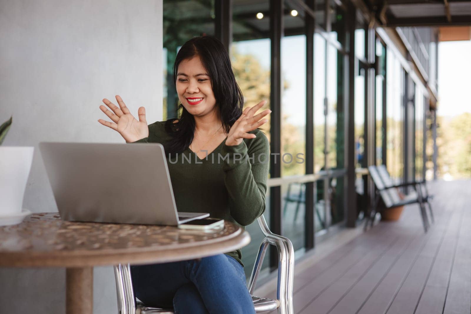 Business woman working from coffee shop using laptop online meeting in home office, Business woman typing keyboard use notebook laptop Smiling, laughing at coffee shop relaxation table.