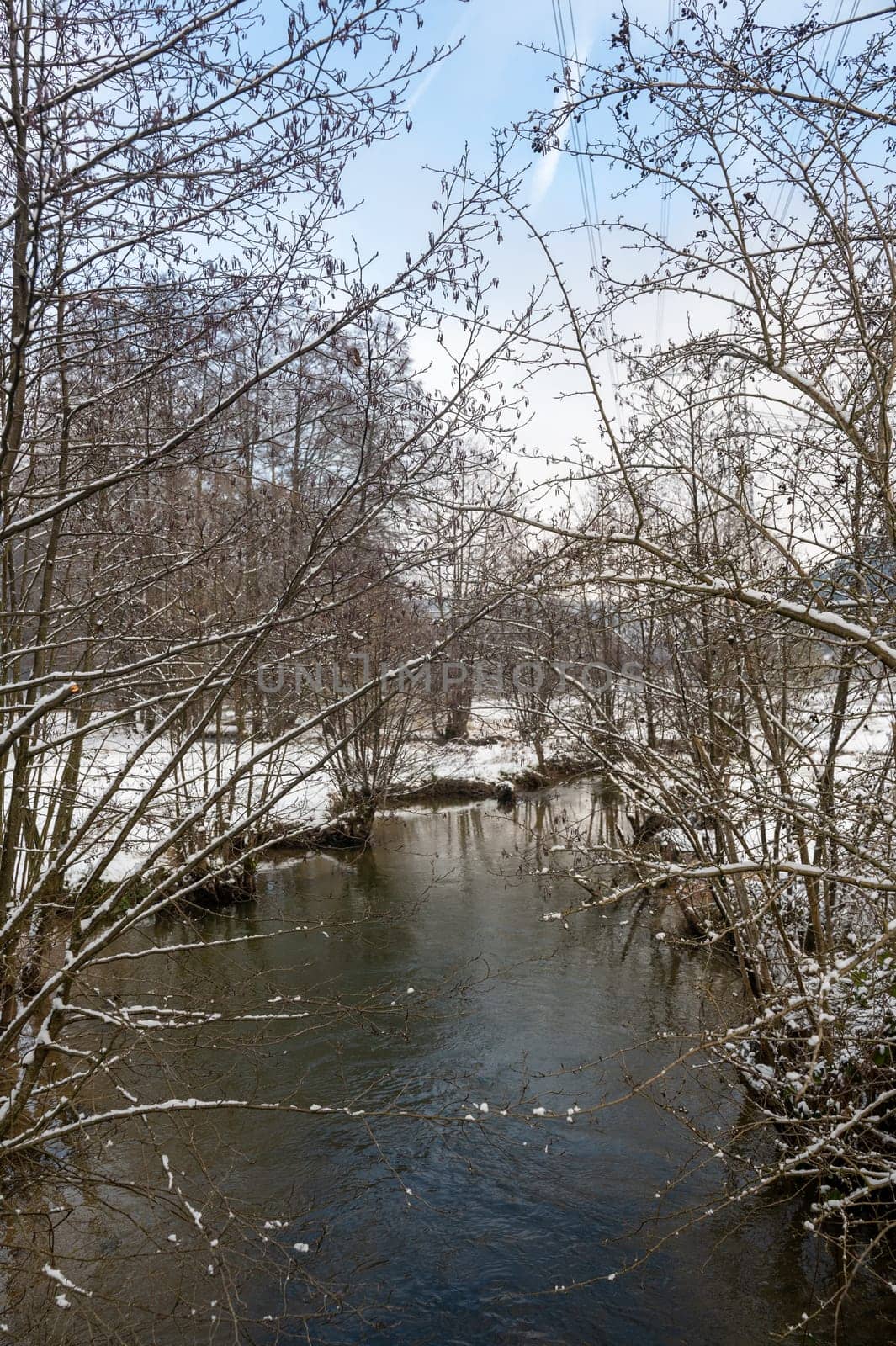 Winter landscape on a small river with snow