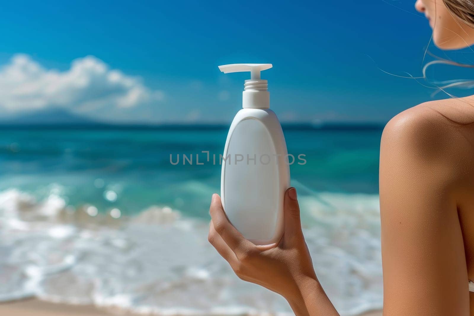 A hand holds a bright white sunscreen bottle against the backdrop of a tranquil, turquoise ocean with a scenic, tropical horizon