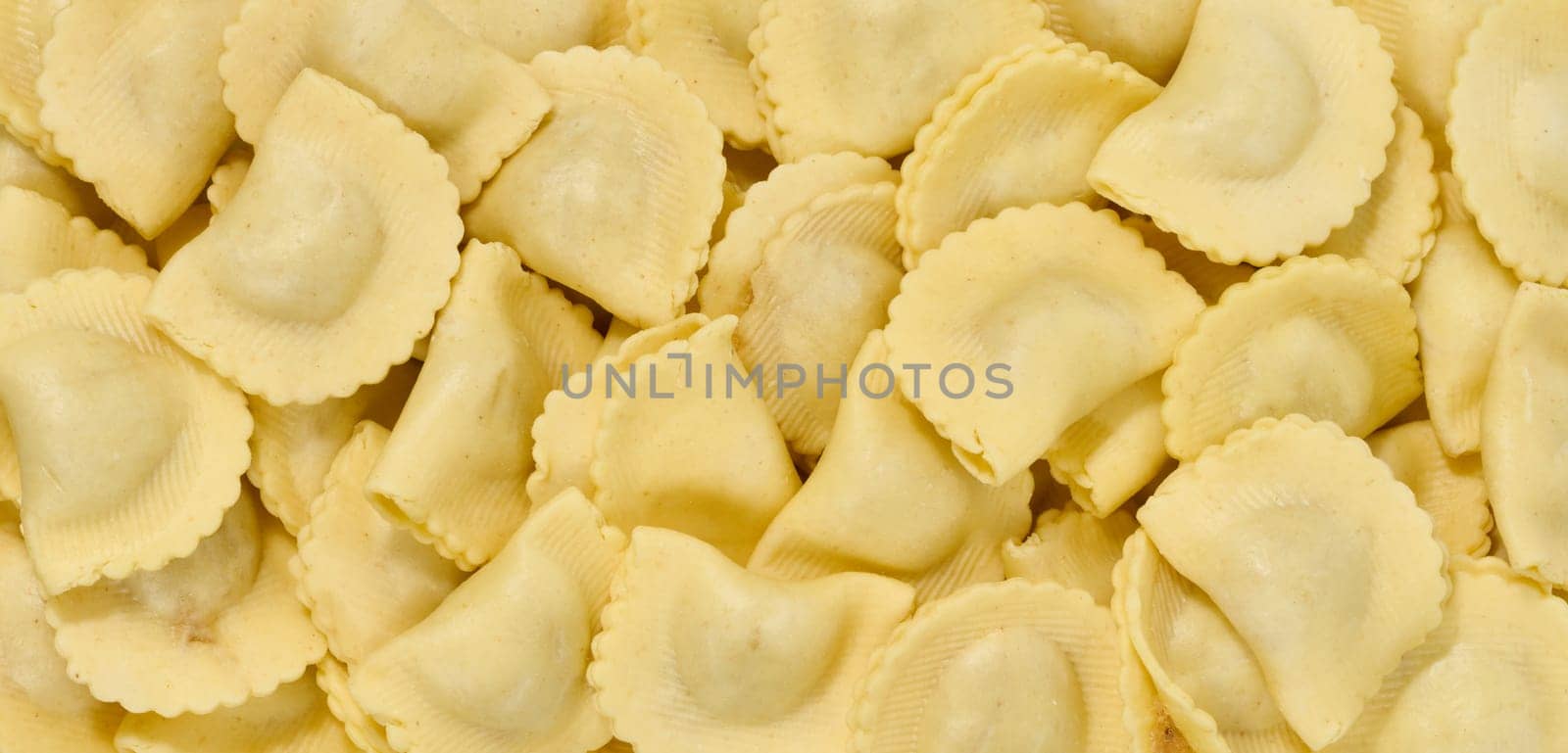 Raw ravioli with filling, full frame. Top view