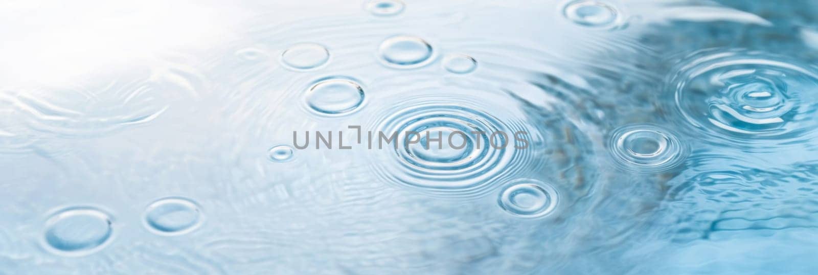 Ripples in clear blue water with abstract circular patterns, suitable as calming SPA background, AI generated