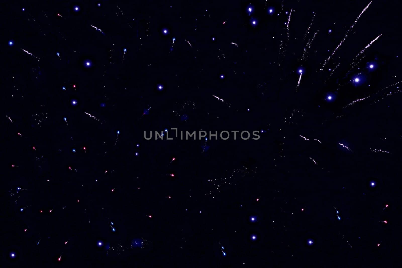 Various bright dots and shapes against a black background
