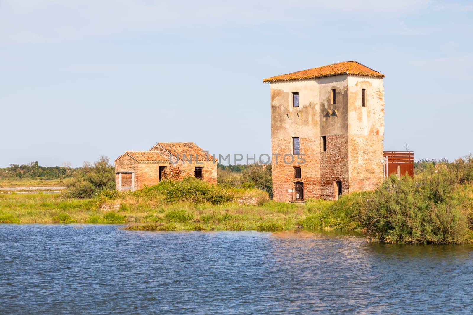 Italy, Comacchio lagoon with blue sky. Panorama with country and canals.