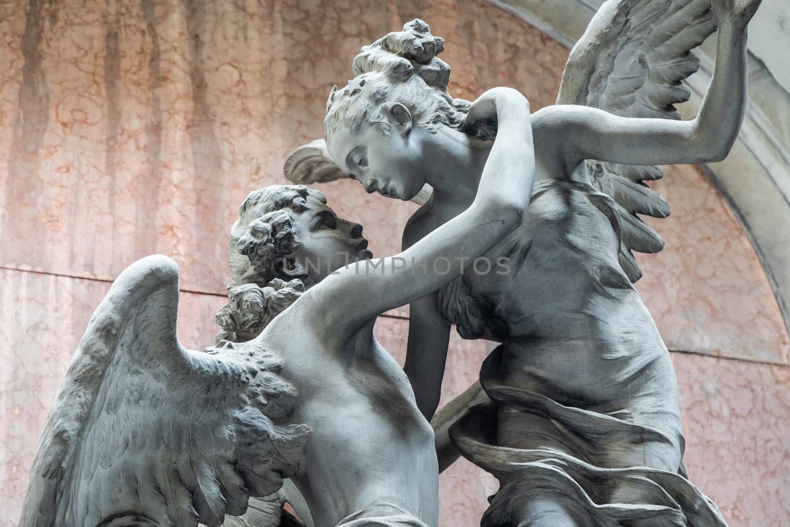 Genoa, Italy - August 17, 2024: Staglieno cemetery. Detail of Bertollo tomb, 1915. Couple of angels, symbol of ethernal love.
