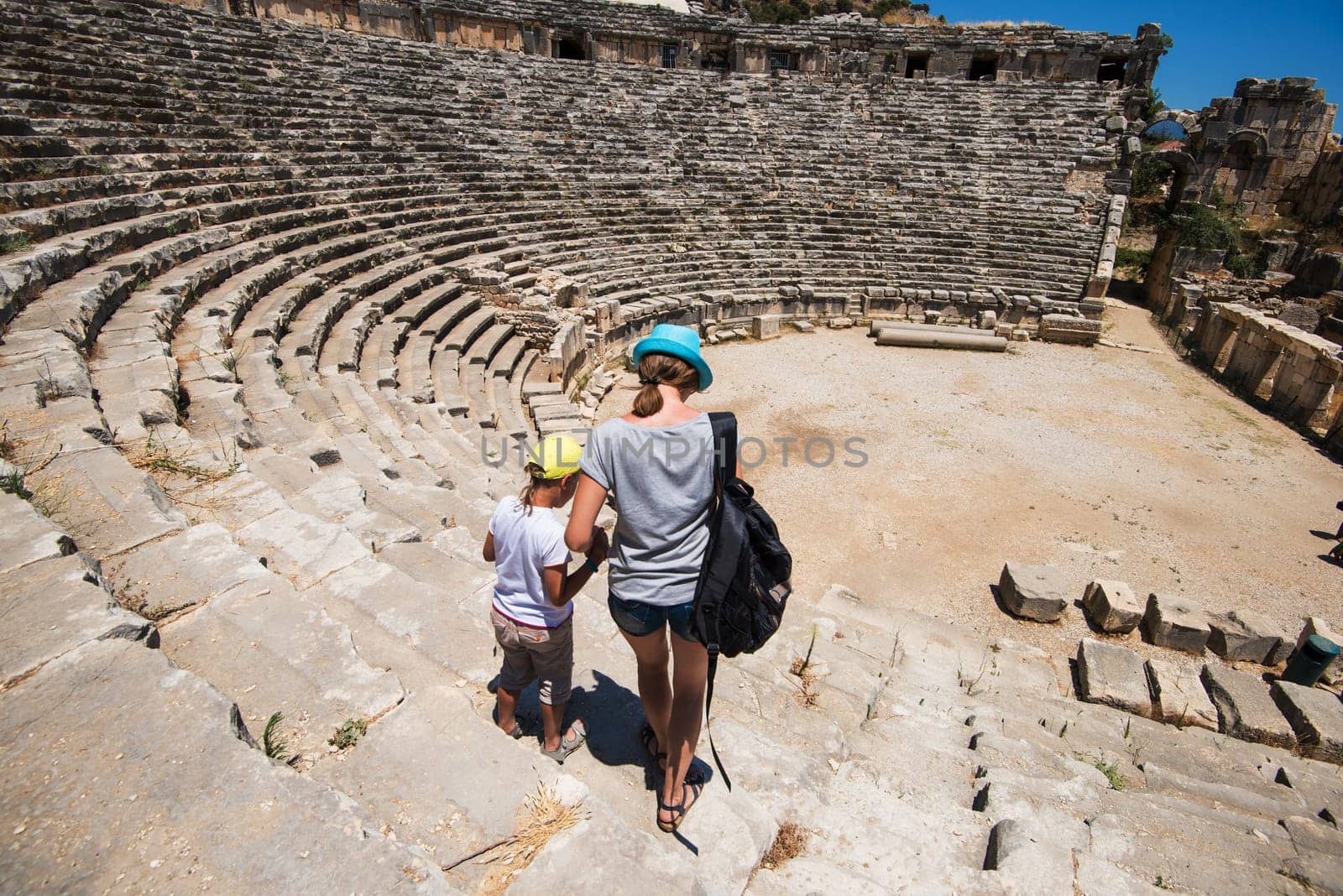 Young woman and her son at theatre in Myra ancient city of Antalya in Turkey.