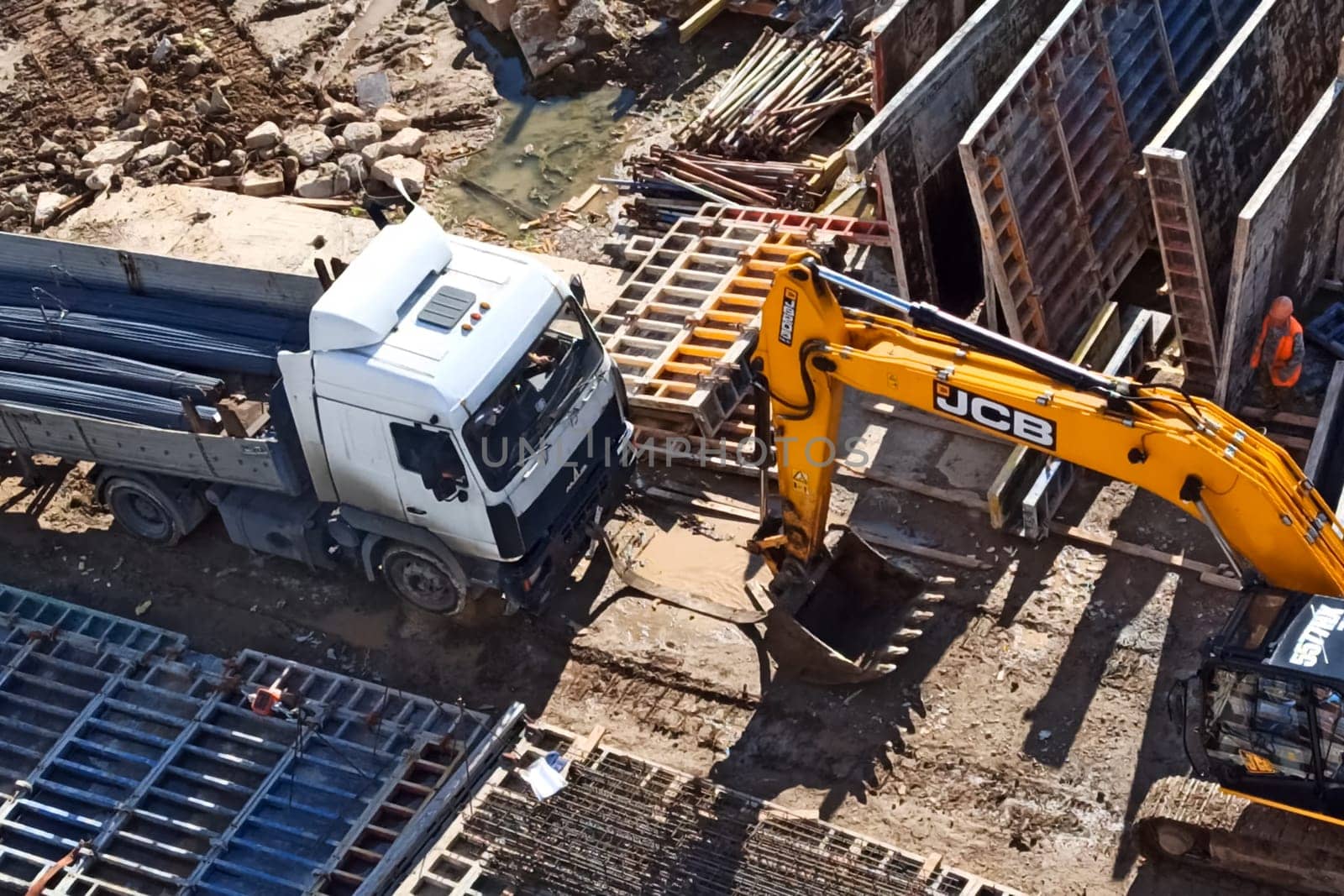 Moscow, Russia - June 24, 2020: A truck and an excavator at a construction site.