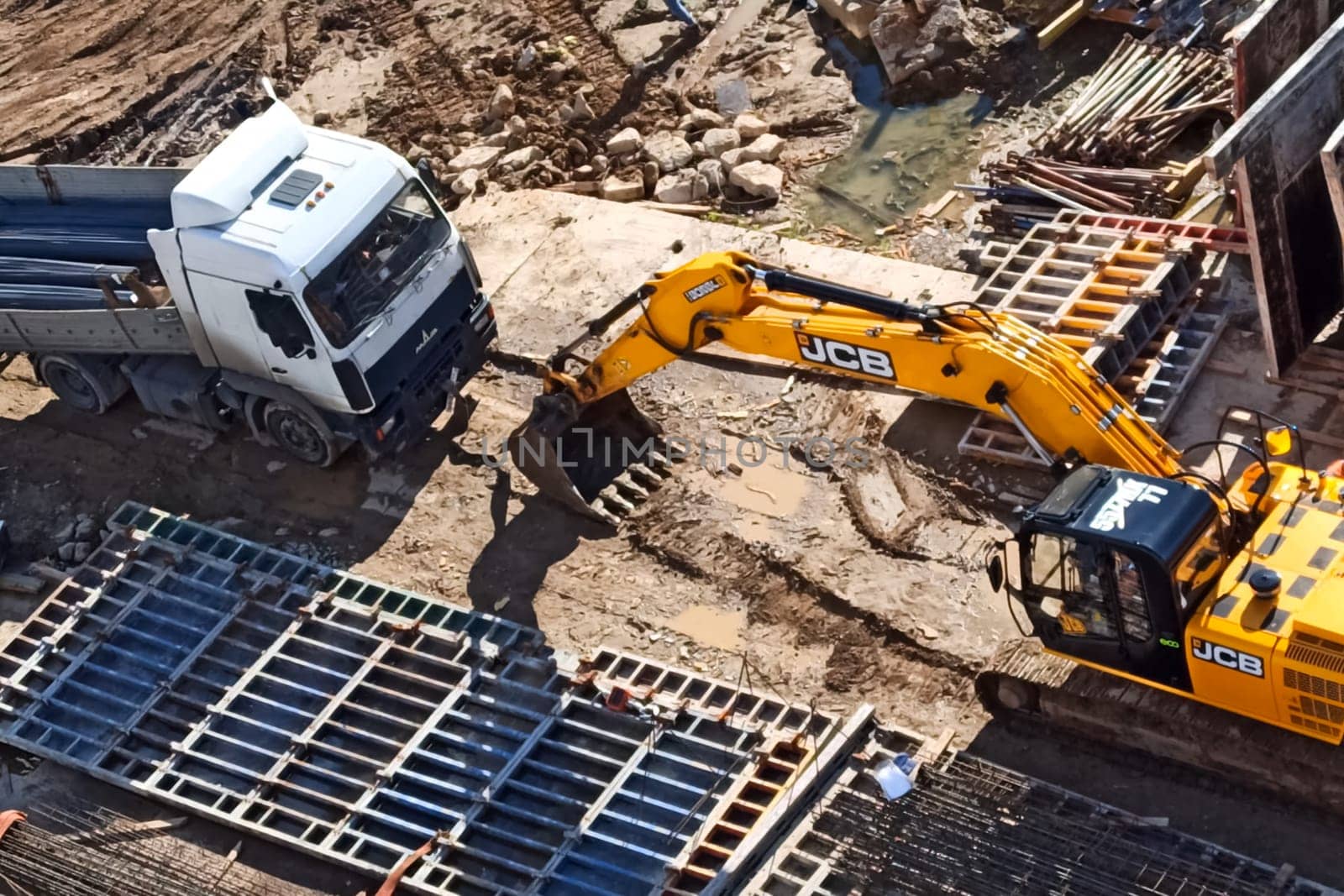Moscow, Russia - June 24, 2020: A truck and an excavator at a construction site.