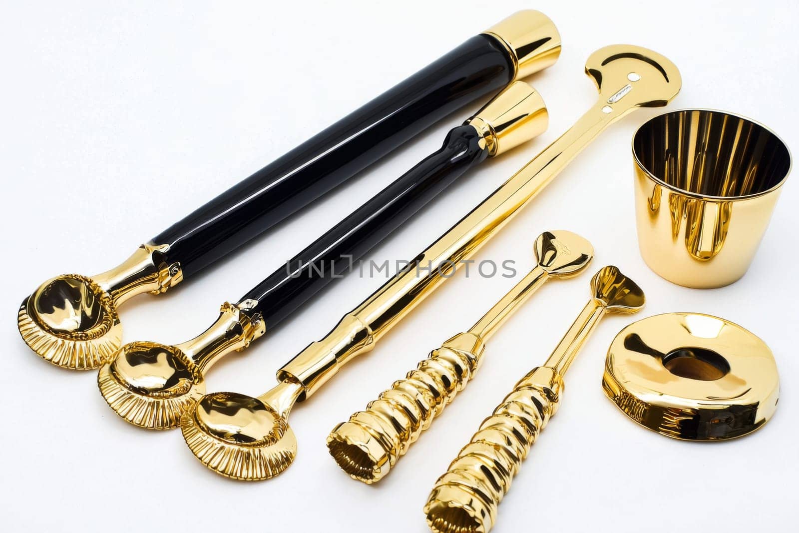 Luxurious cocktail utensils shine in gold, ready for a mixologist to create delightful beverages at a chic gathering.