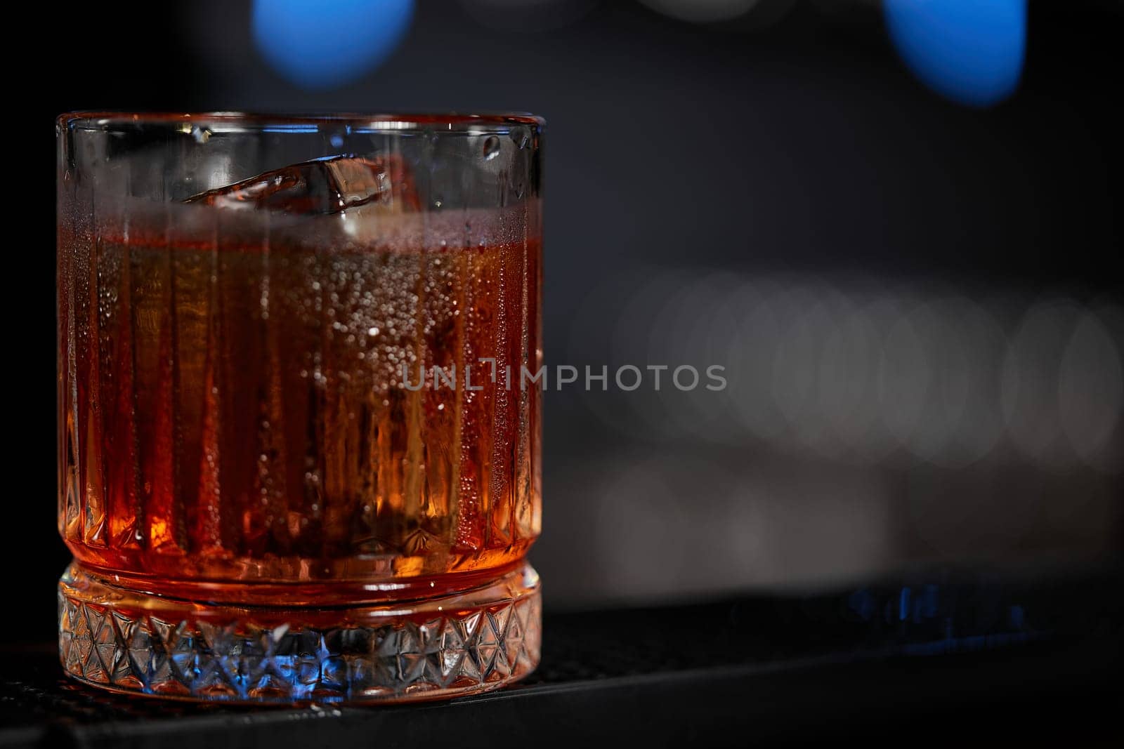 whiskey glass at the bar, close-up. copy space