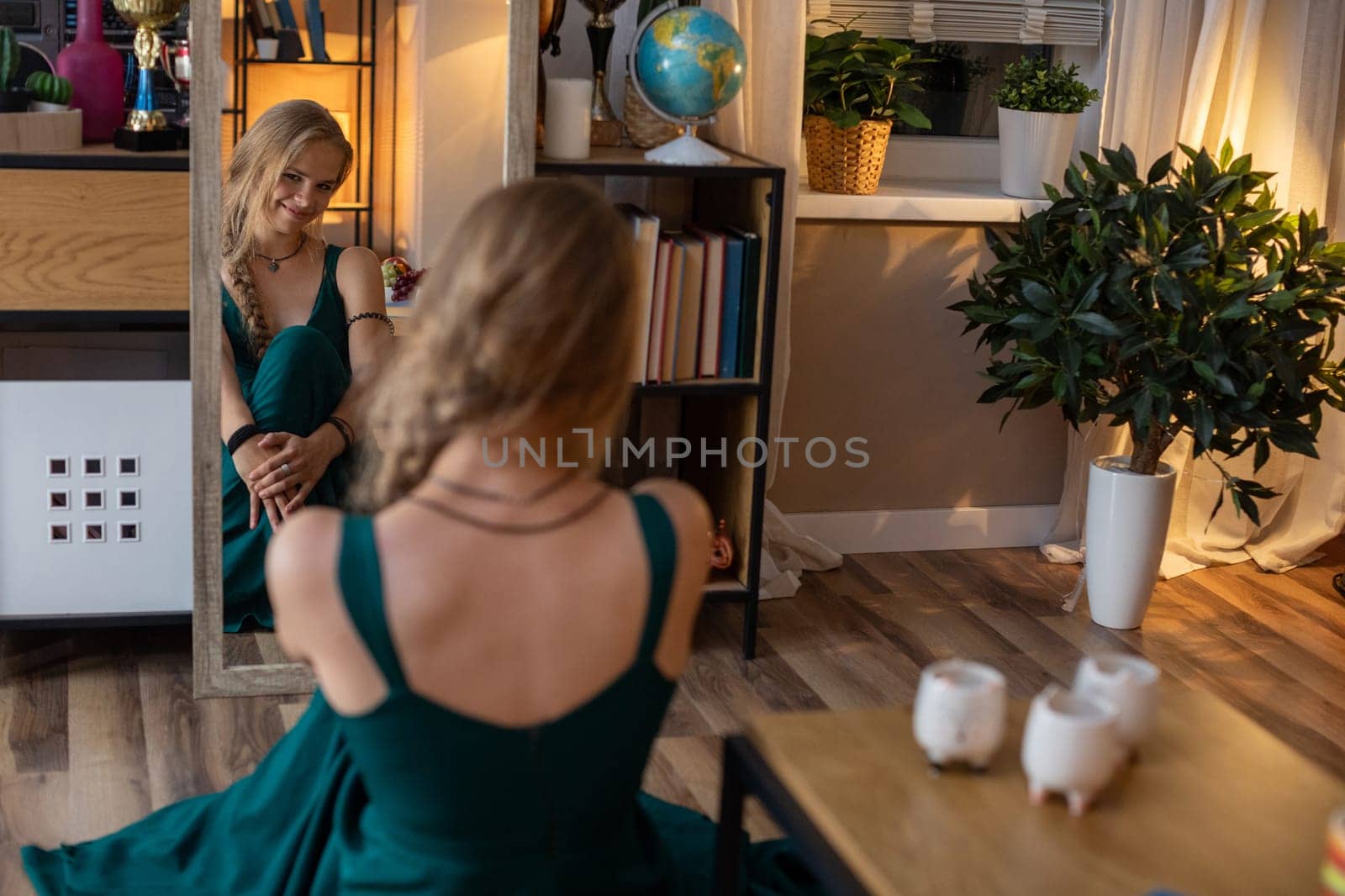 A tranquil and serene scene showcasing a woman in an elegant green dress beautifully reflecting in a mirror