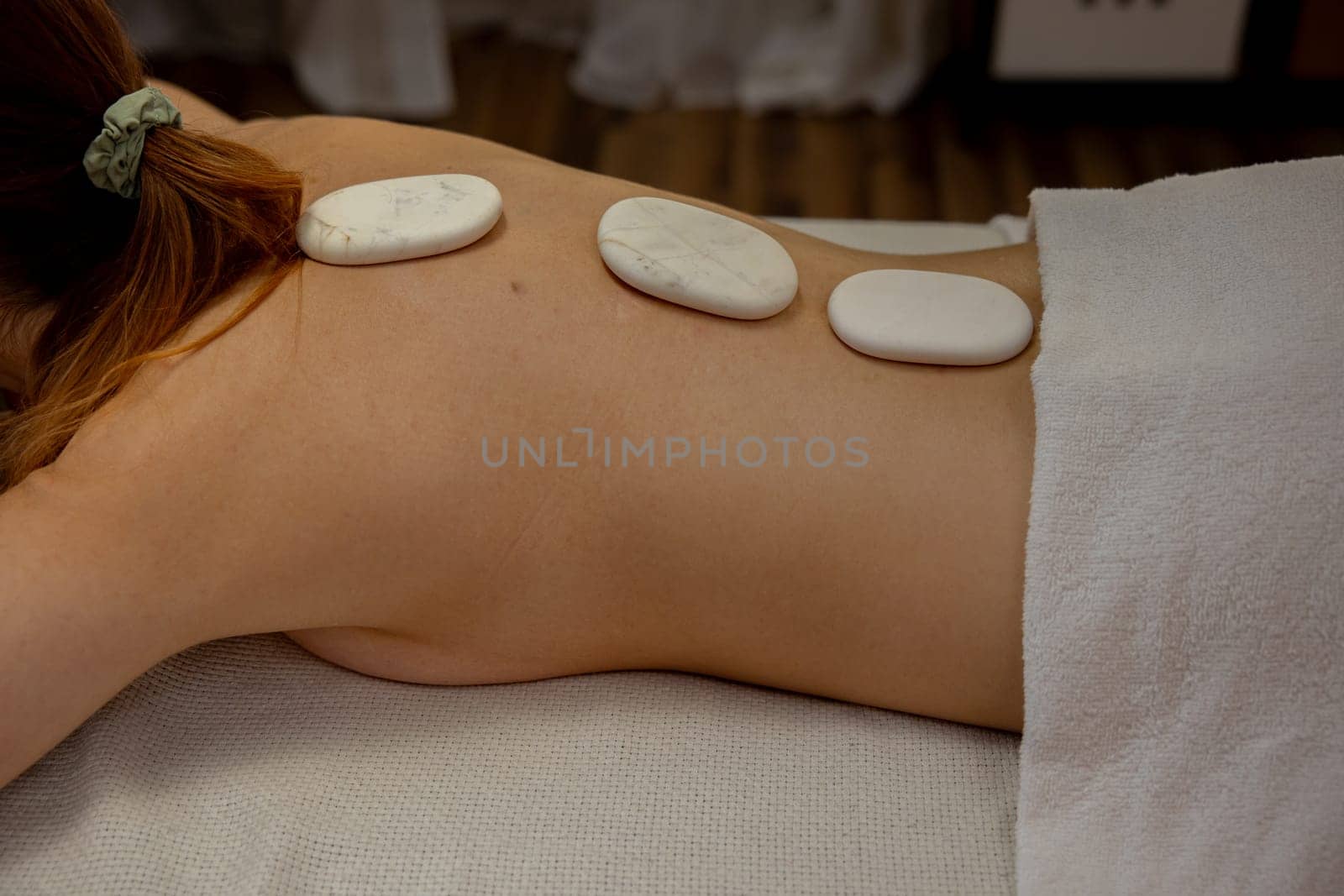 Indulging in relaxing hot stone therapy provides significant wellness benefits, rejuvenating both the mind and body