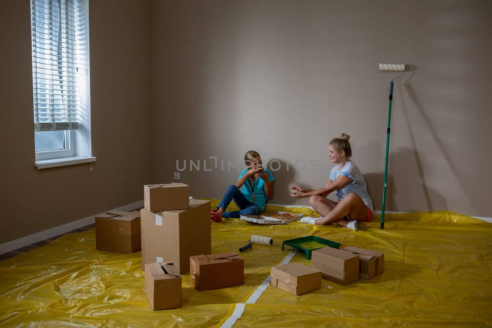 Children are happily engaged in playful activities while their home is undergoing a significant renovation
