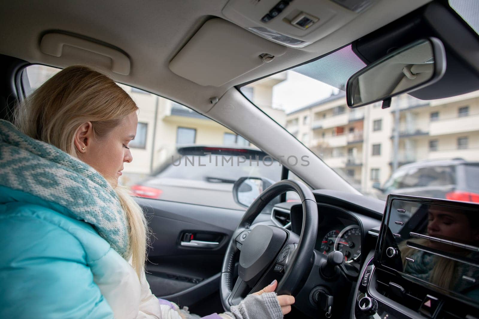 A confident woman driving her car, showcasing innovative vehicle design and urban living experience