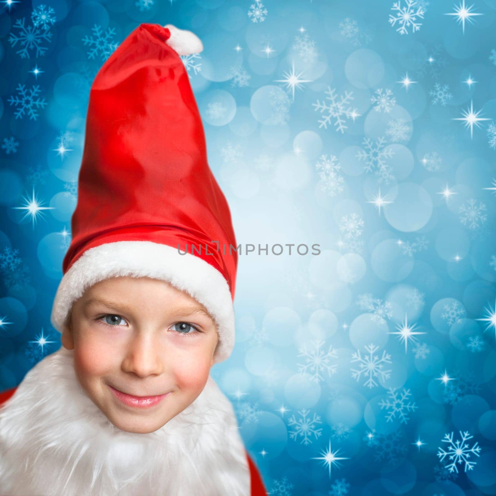 snowing on child in santa clothes