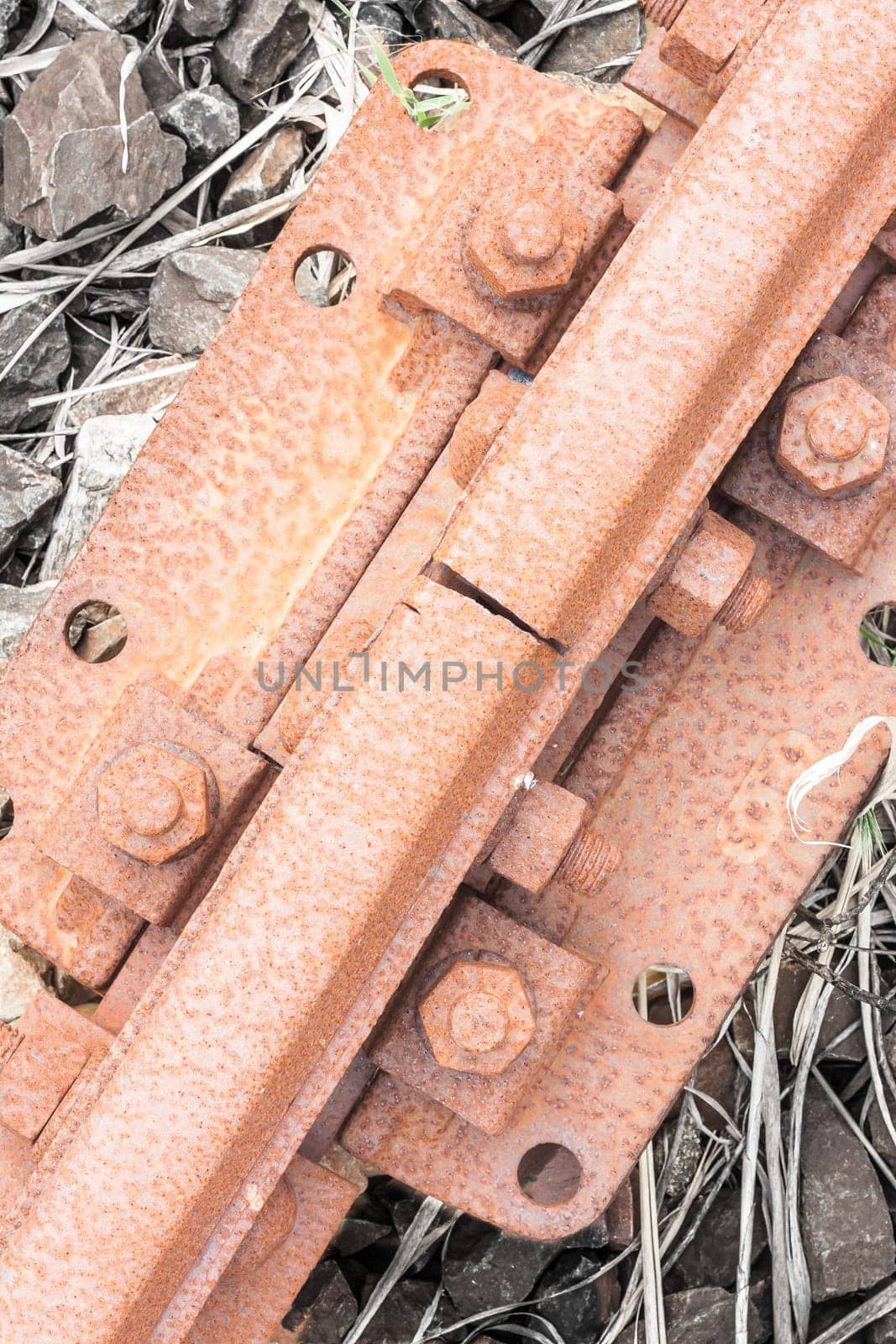 Bolts rusted tracks. Particular of a rail tie with track and rusted bolts