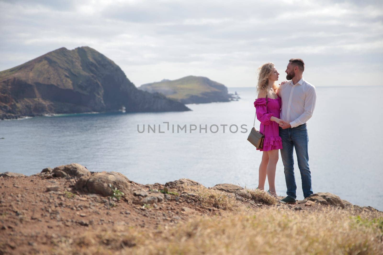 Tourists admiring the breathtaking coastal view of ponta de s o louren o, madeira island, portugal