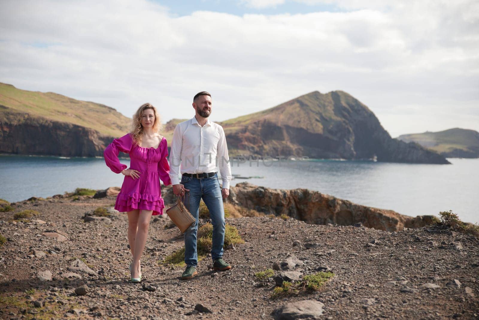 Happy couple walking along ponta de s o louren o peninsula in madeira island, portugal, enjoying the scenic landscape