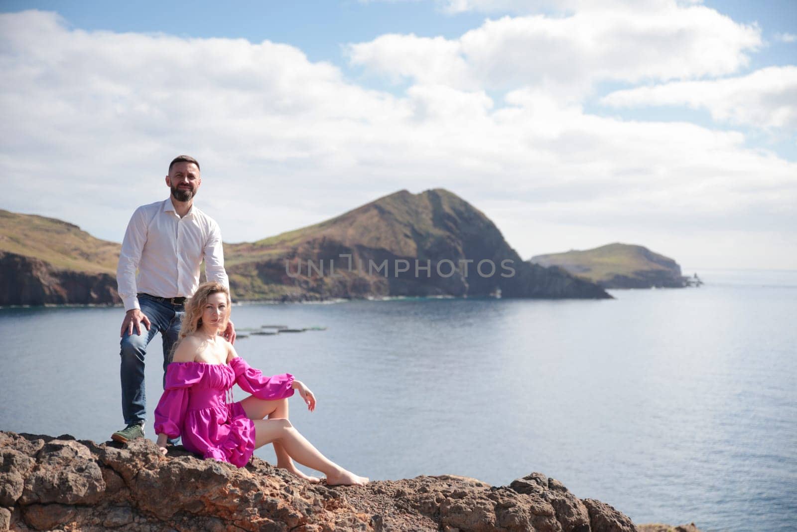 Tourists relaxing on rocky coast enjoying breathtaking view of volcanic ponta de s o louren o peninsula, madeira island, portugal