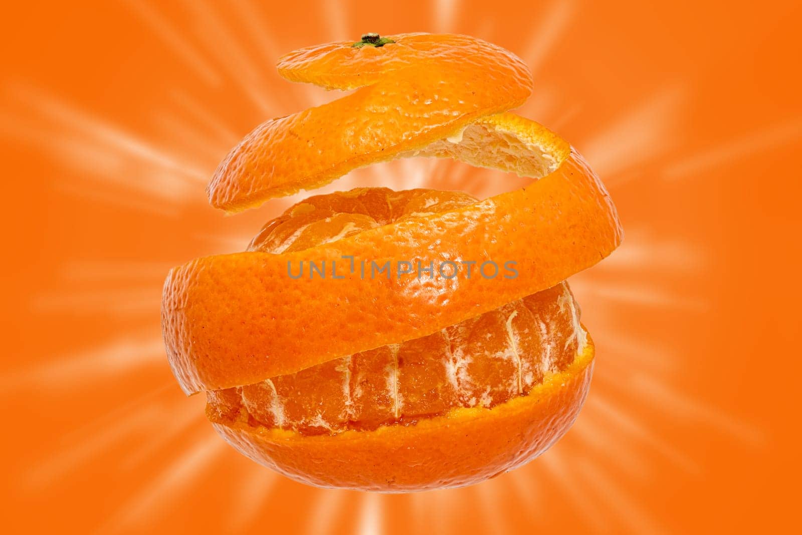 Tangerine peeled off all around in a strip against a orange background