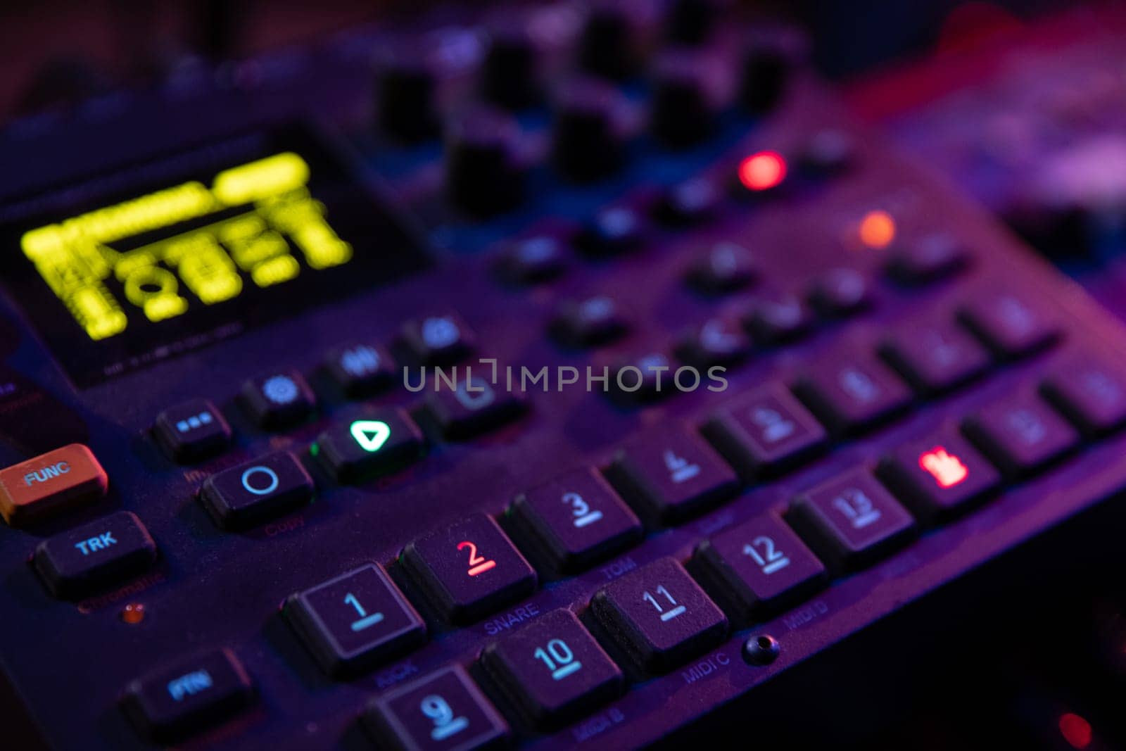 Closeup view of a sophisticated music production device, highlighting its vibrant controls and settings