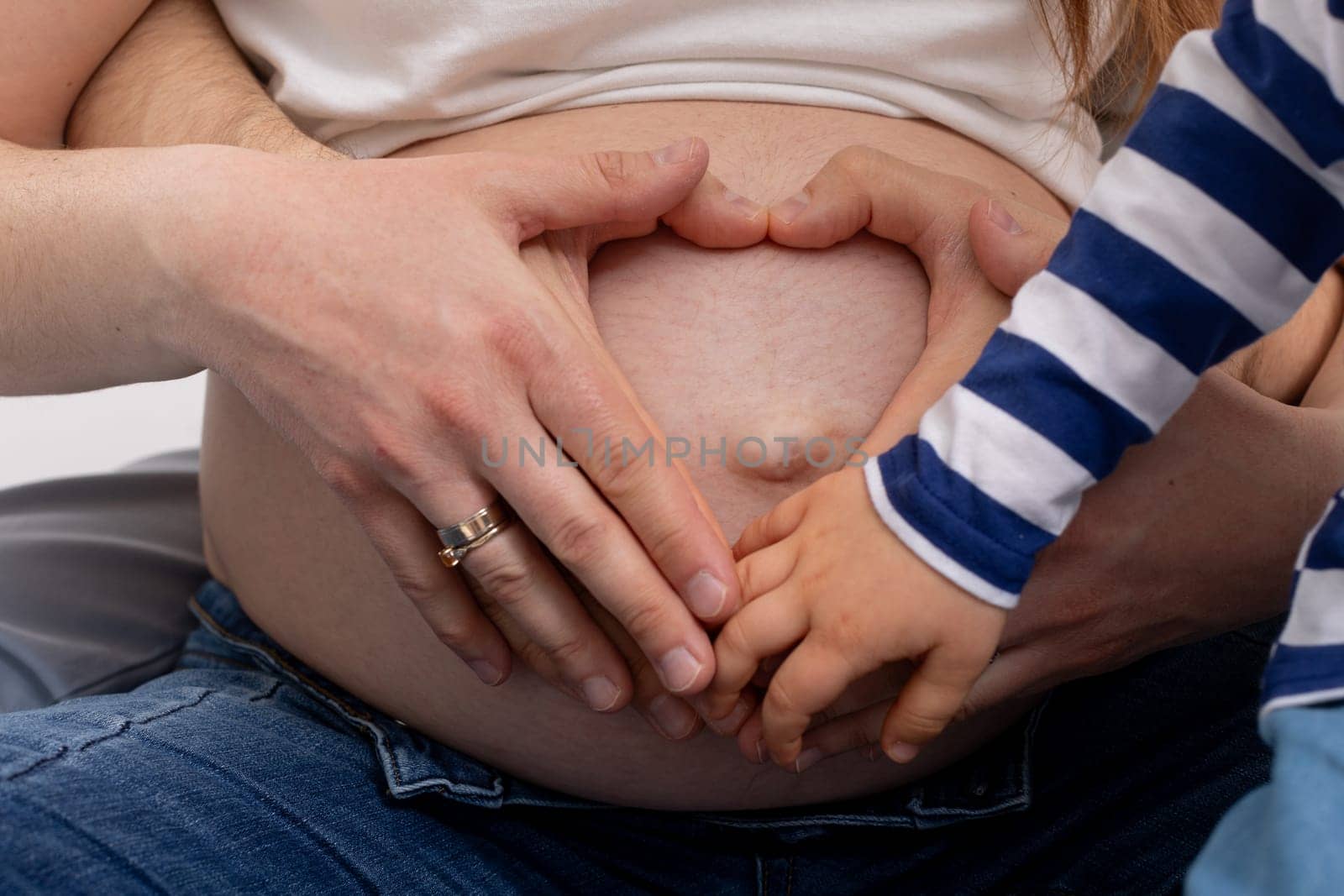 A beautiful moment shared between a pregnant mother and her child, symbolizing love and family connection.