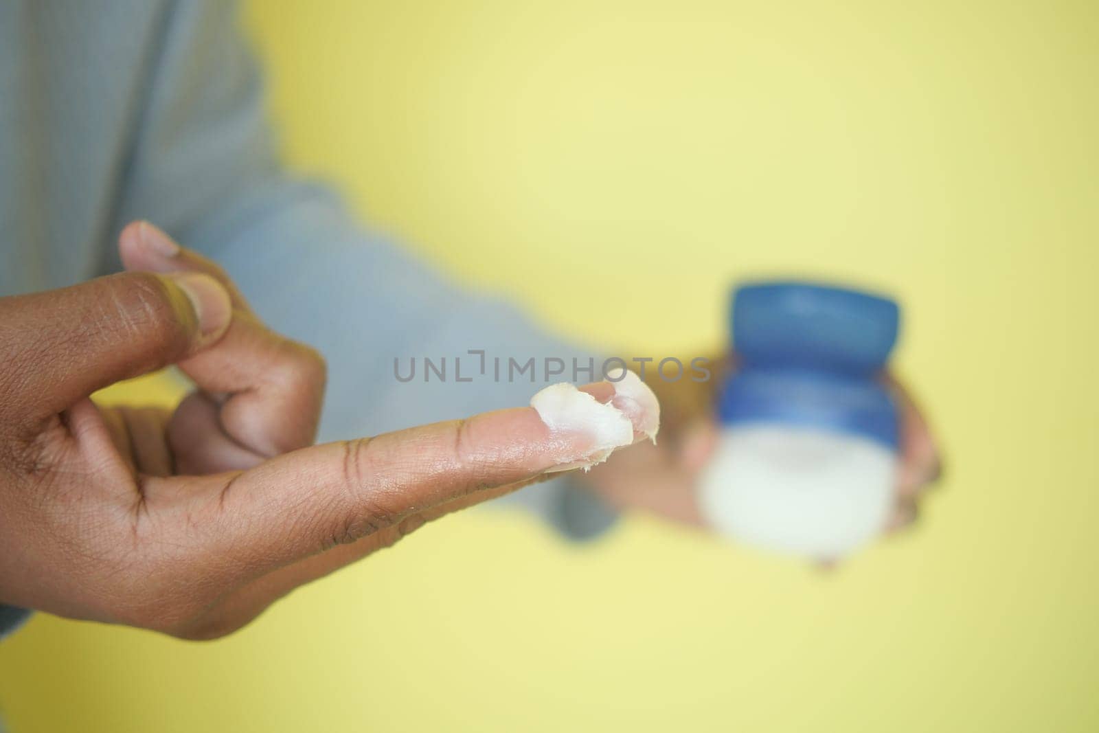 Close-up of petroleum jelly on fingers.
