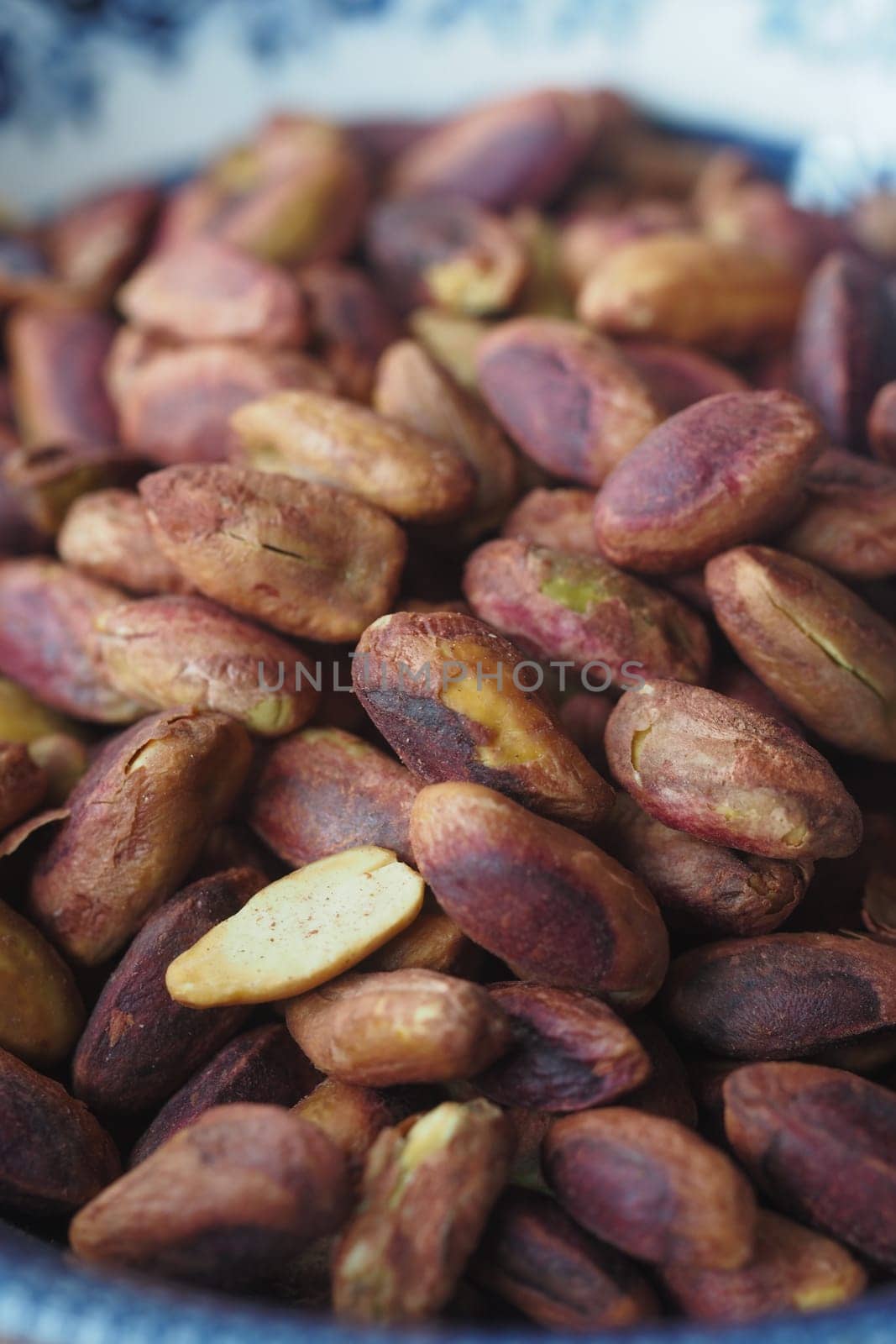 Dried cocoa beans are piled together, showcasing their rich brown color.
