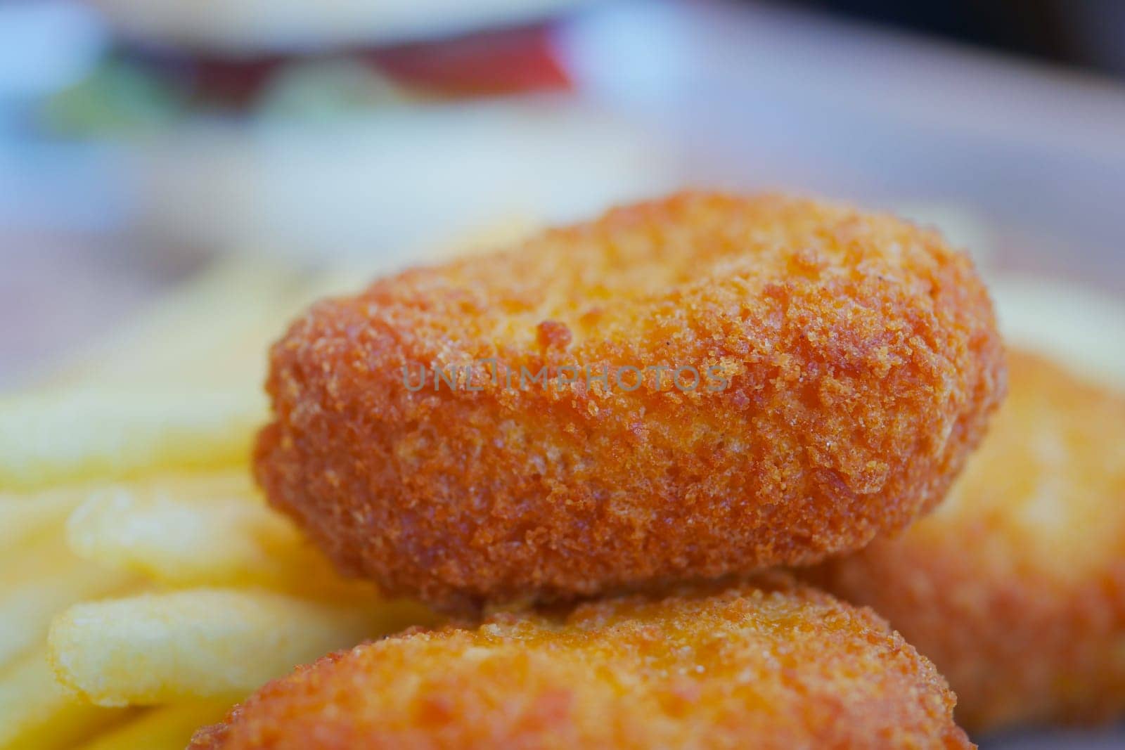 Delicious golden nuggets alongside crispy French fries in a cafe.