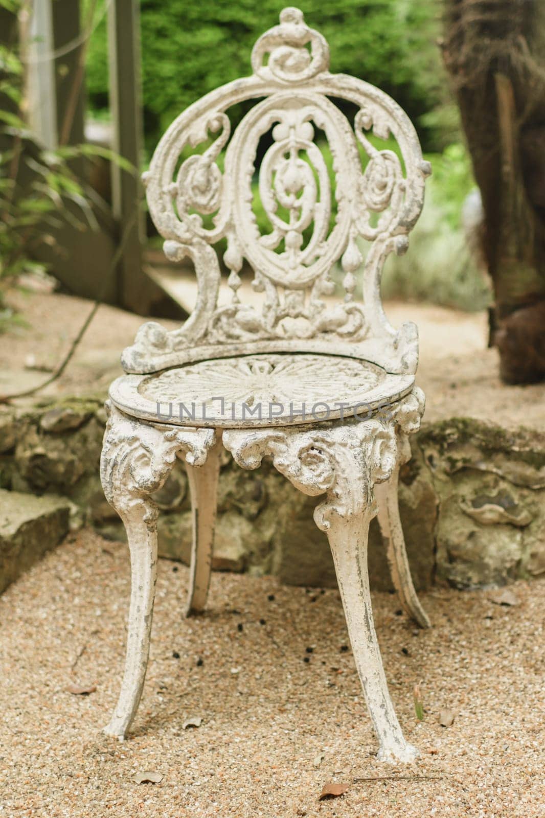 White patterned vintage antique wrought iron-shod chair