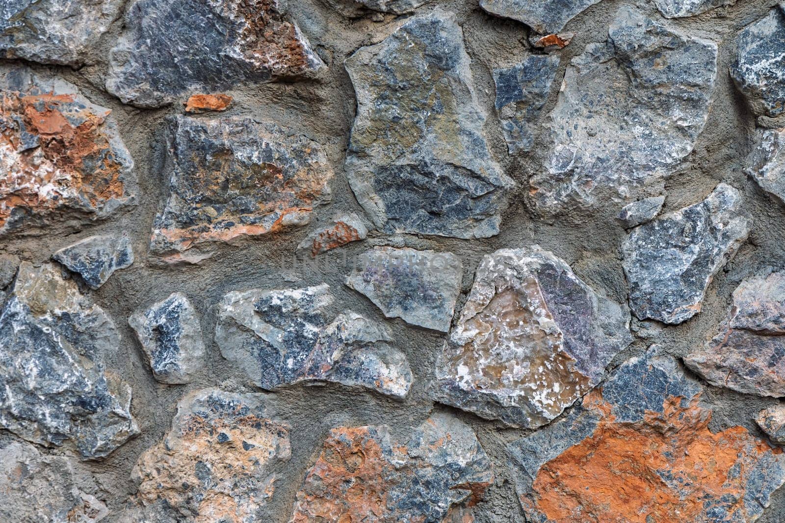 Rough stones with varying colors and shapes come together, creating a striking natural aesthetic with a rustic charm.
