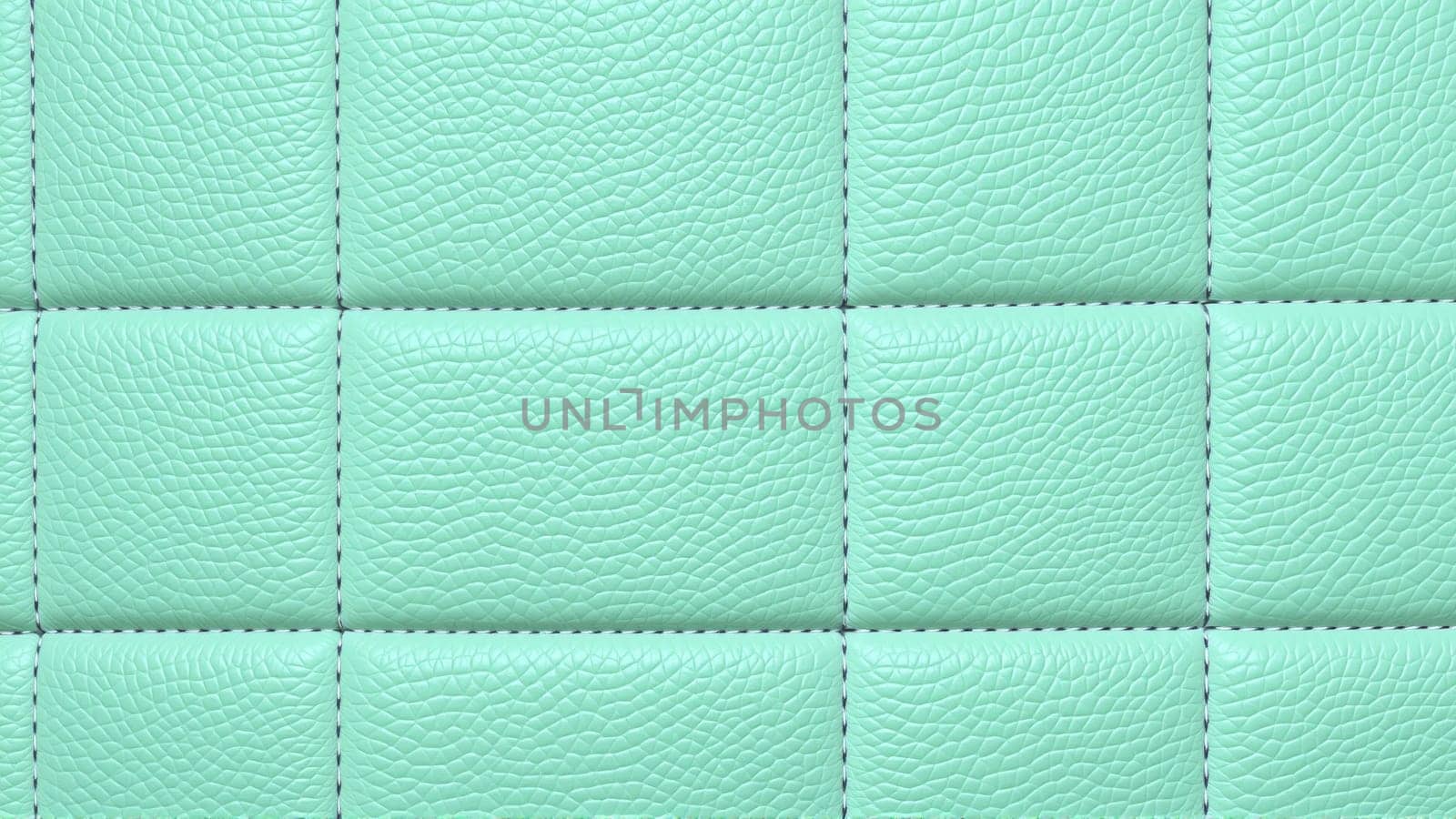 The surface texture of artificial leather in mint color, stitched in the form of rhombuses, squares, rectangles. Quilted eco-leather. High quality photo