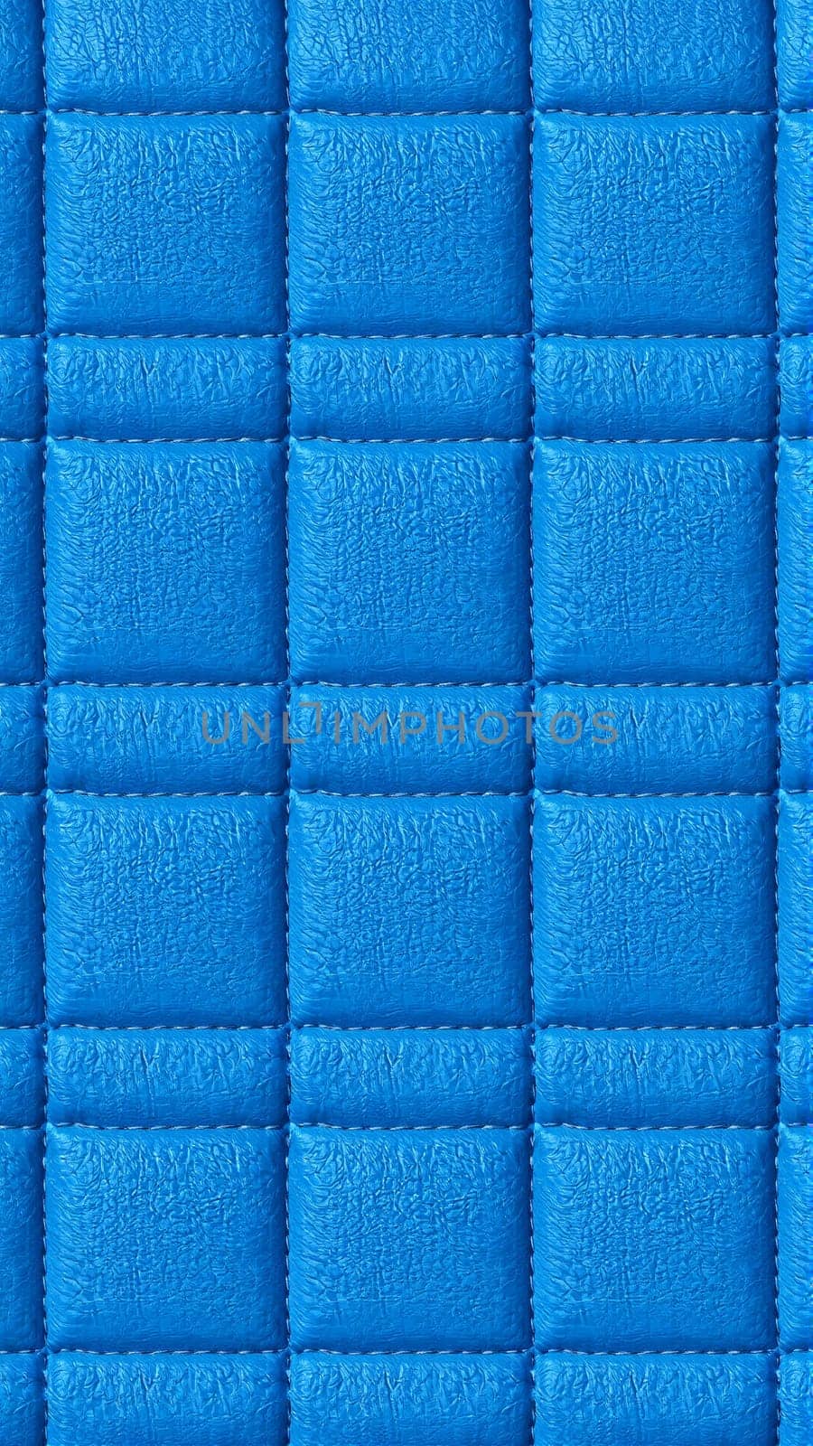 The surface texture of artificial leather is blue, the surface is stitched in the form of diamonds, squares, rectangles. Eco-leather in a kilt. High-quality photos