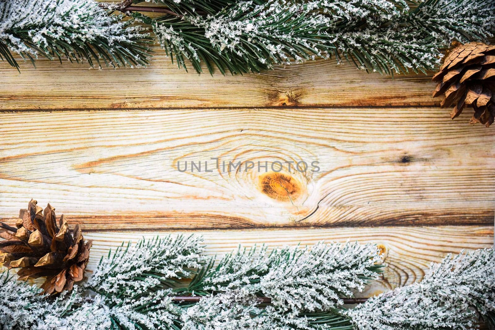 Wooden Christmas background frame with snowy fir tree branches and cones. new year design, copy space
