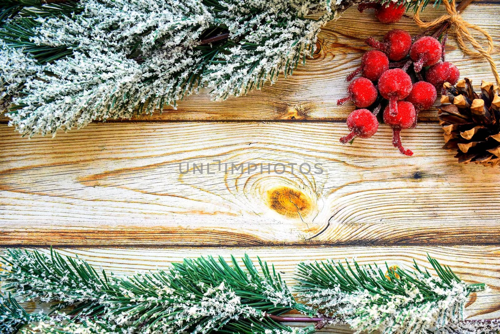 Wooden background frame with snowy fir tree branches, Christmas berries and fir cone. new year design, copy space