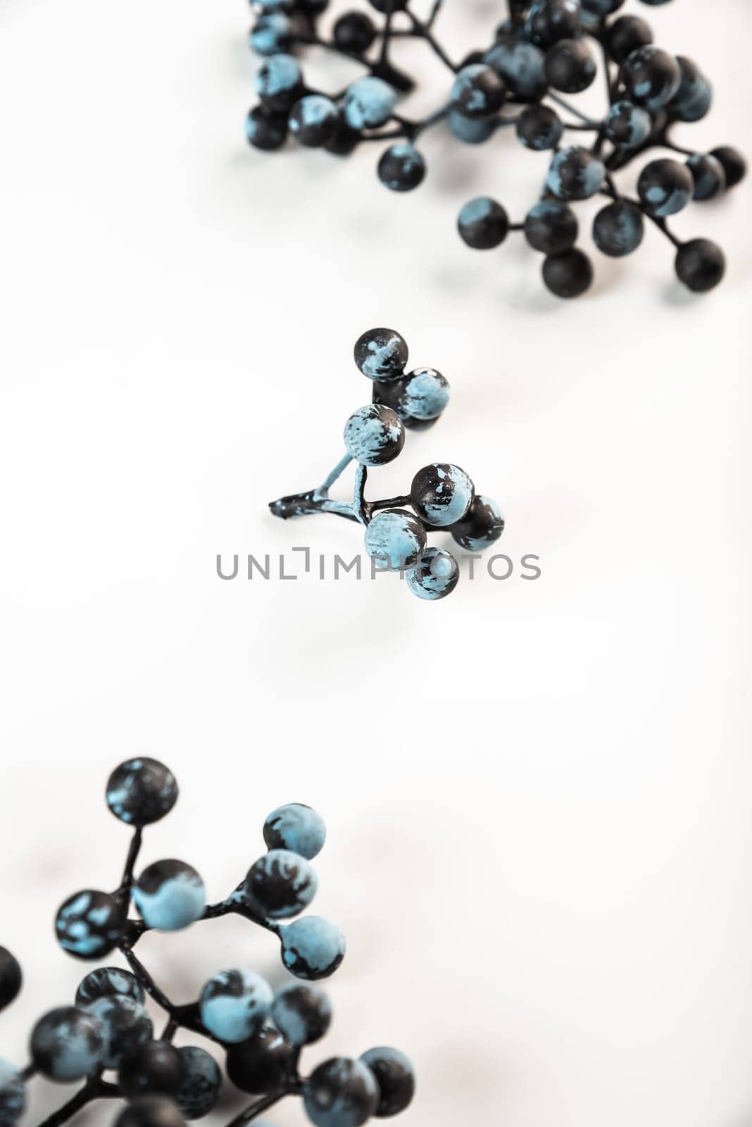 Artificial berries on a wire for needlework and decoration of gifts, wreaths on white background