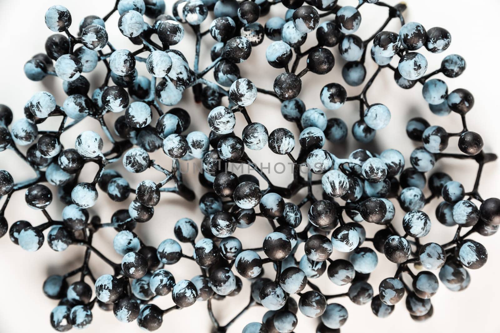 Artificial berries on a wire for needlework and decoration of gifts, wreaths on white background