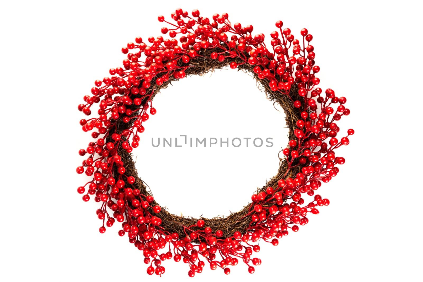 Christmas wreath made of artificial red berries branches for home decoration, on a white background